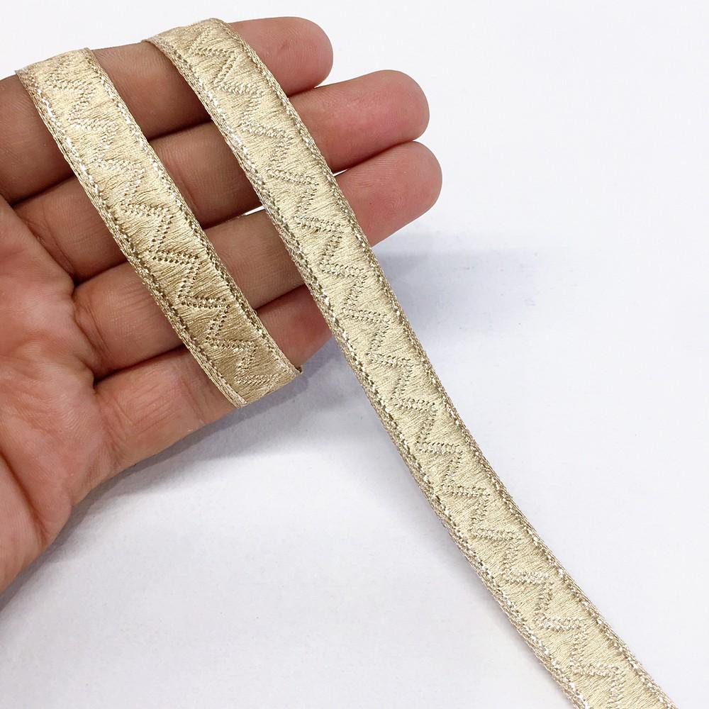 14 mm Thick Gold Metallic Zari Zig-Zag Embossed Ribbon, shown on white cotton