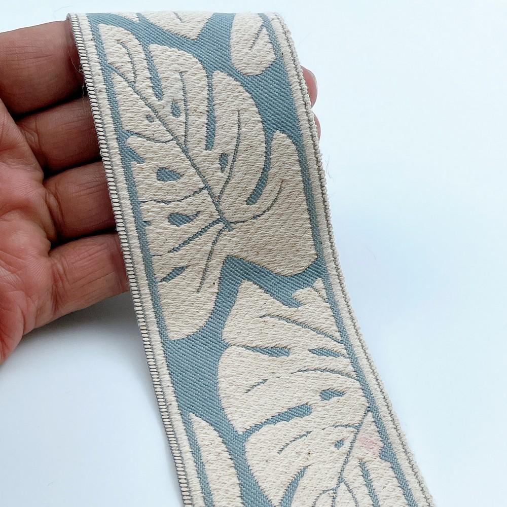 58mm Wide Tropical Monstera Leaf Pattern Lace Border for Sewing, Garments, DIY Crafts & Home Decor, shown on white cotton