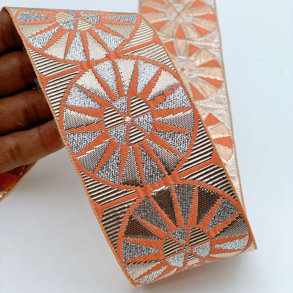 60mm Wide Colorful Sunburst Gota Work Jacquard Ribbon - Woven Border, shown on white cotton